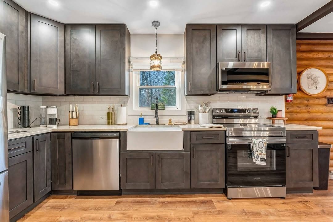 Deep-cleaned kitchen with dark cabinets and farmhouse sink
